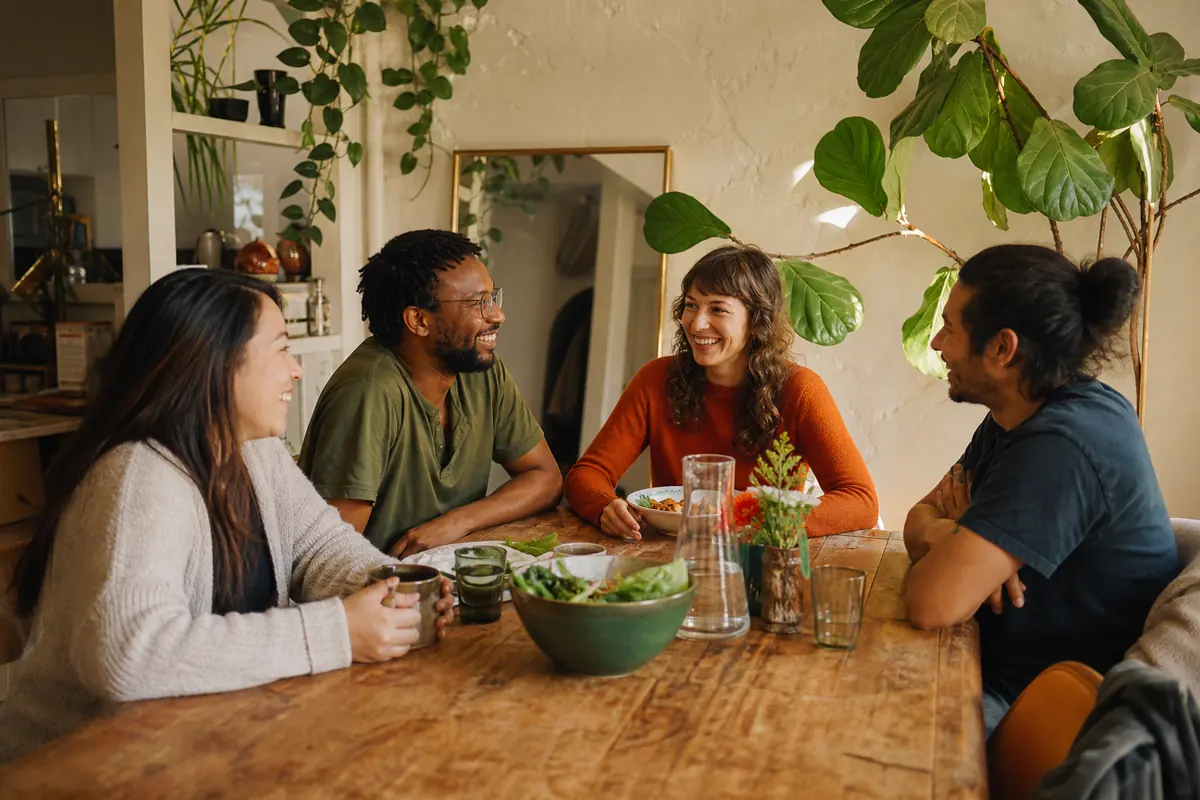 Four people talking over coffee — the conversation we're trying to make easier.